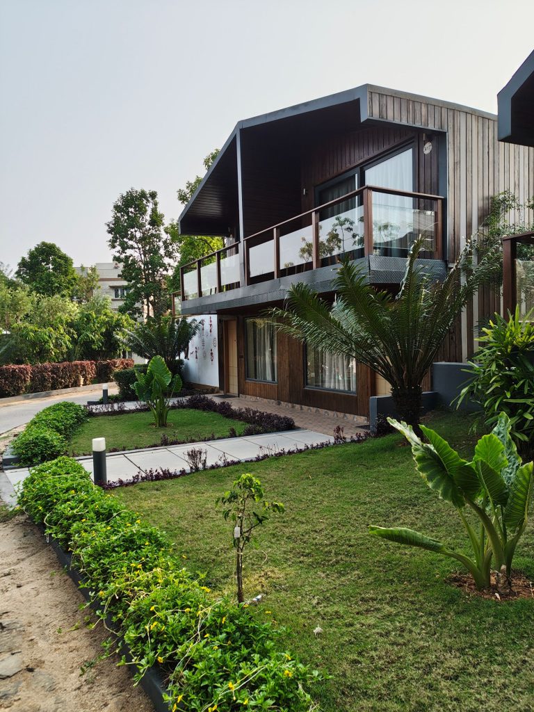 Modern Indian home with a landscaped garden, lawn, clipped hedges and tropical planting
