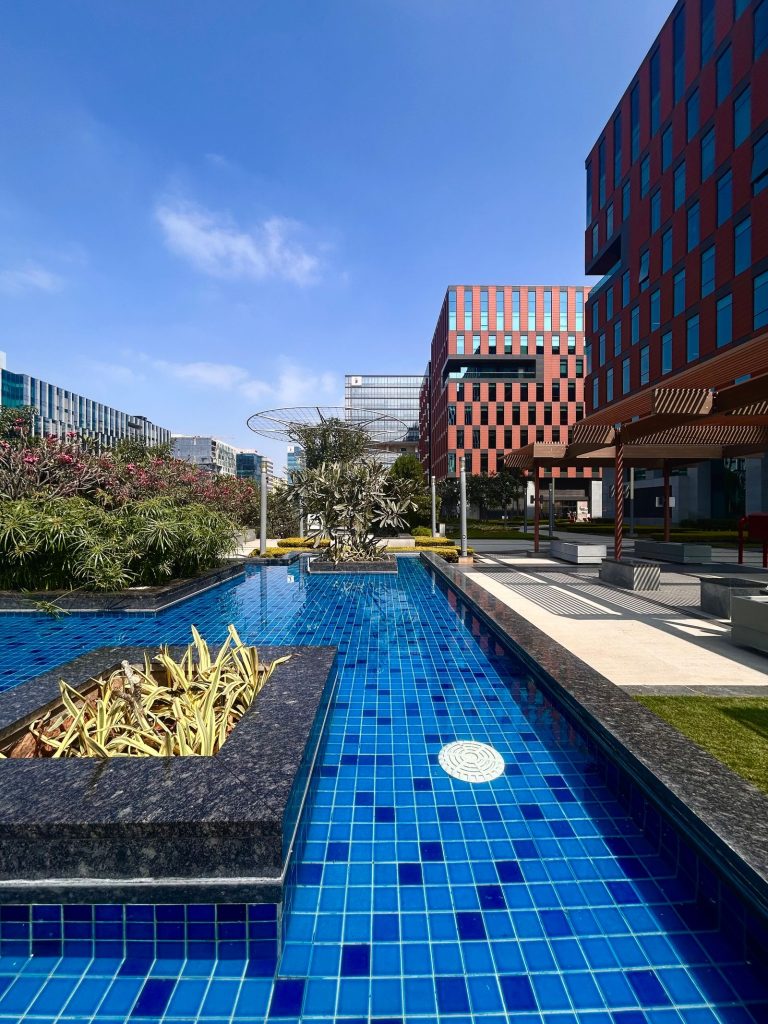 How to Select the Best Business Landscape Contractors in Bangalore 7 Premium corporate campus landscape with a tiled water feature, pergola and planting beside modern office buildings