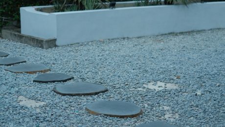 Low-maintenance garden with a gravel path, stepping stones and drought-tolerant agave planting