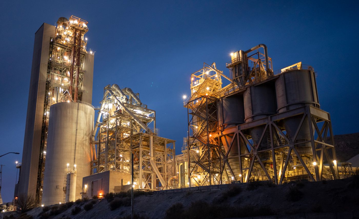 A cement plant’s kiln line, pre-heater tower and clinker silos — among the emission sources a green belt is designed to screen.
